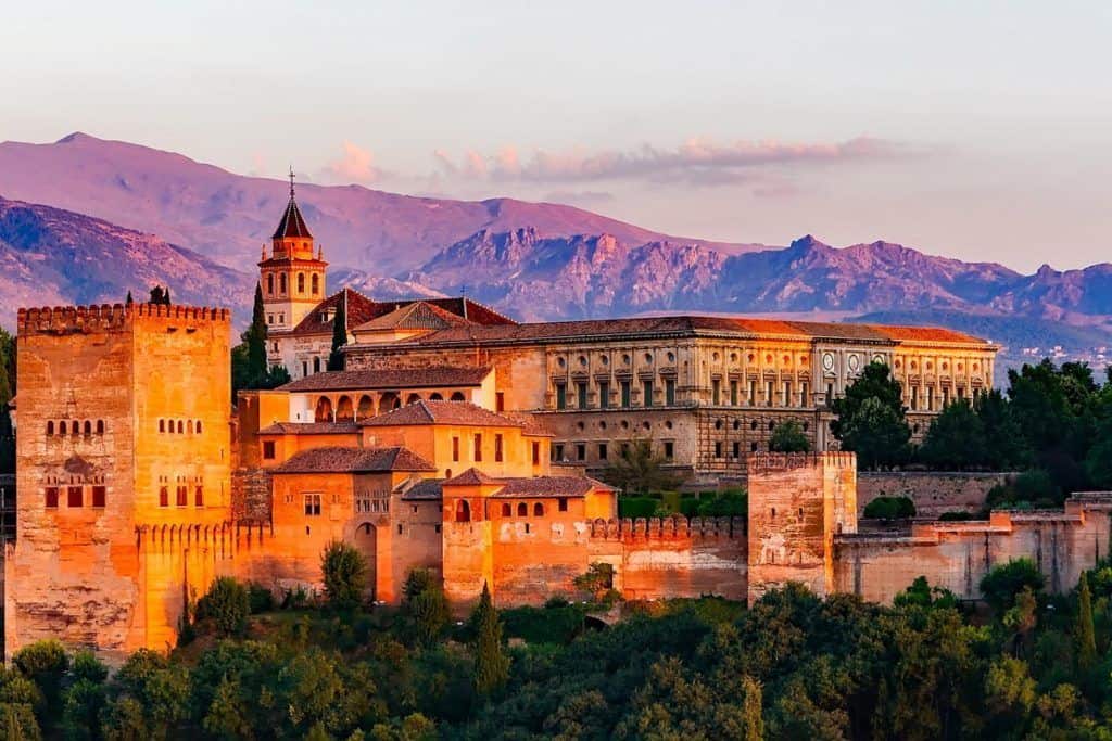 Historic Alhambra Palace in Granada at sunset, part of our custom tours from Malaga.