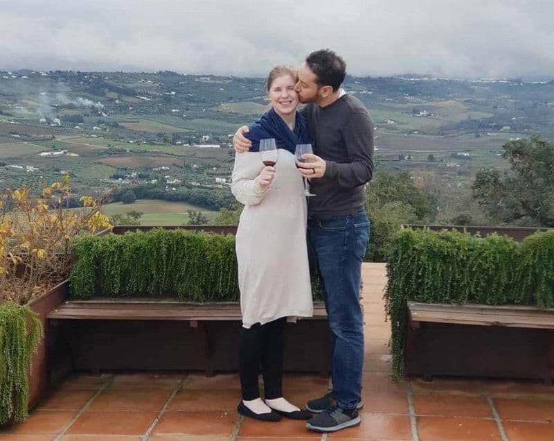 Couple enjoying wine tasting in Ronda's vineyards with scenic views.