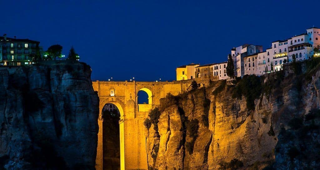 Beautiful night view of the Puente Nuevo bridge in Ronda, Andalusia, illuminated against the night s.