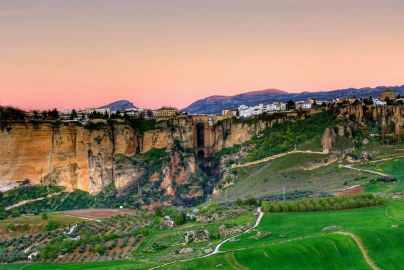 Scenic view of cliffs and green landscape in Costa del Sol at sunset.