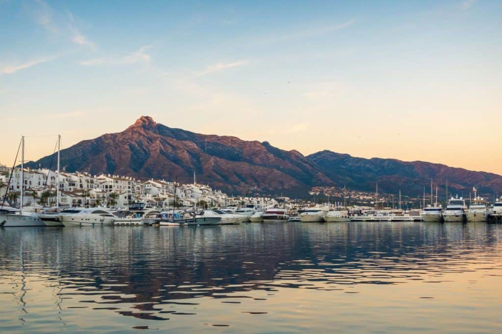Beautiful coastal scenery of Malaga and Marbella with yachts and mountains in the background.