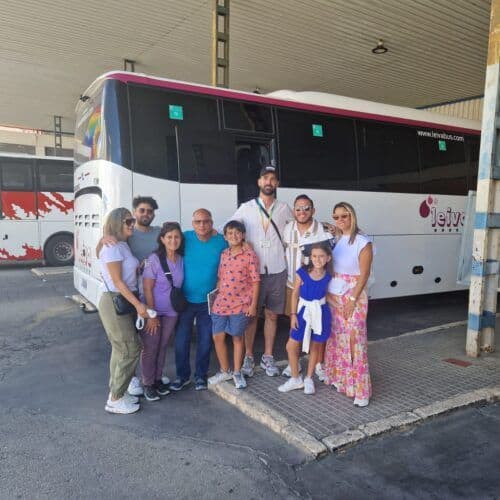 Group of tourists with guide at bus station in Costa del Sol.
