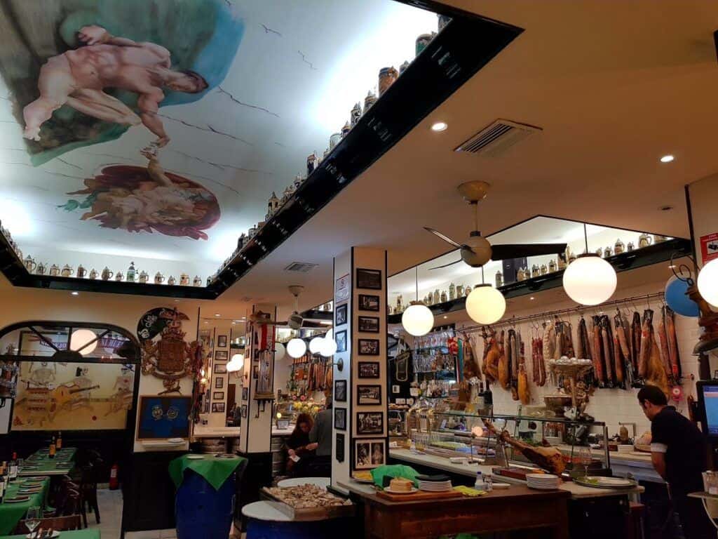 Traditional Malaga restaurant interior with local dishes and vibrant decor.