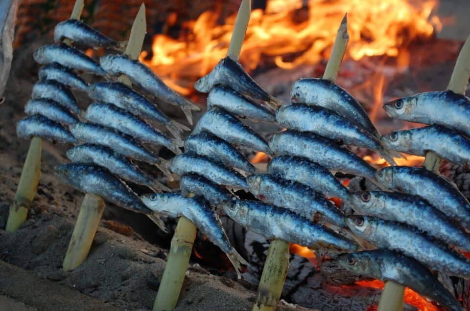 Fresh sardines grilled over open flame, perfect for local Malaga cuisine.