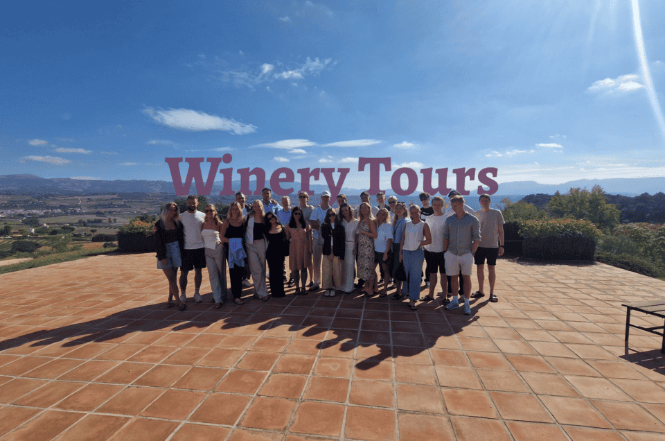 Group of people enjoying a winery tour in Costa del Sol with scenic views.