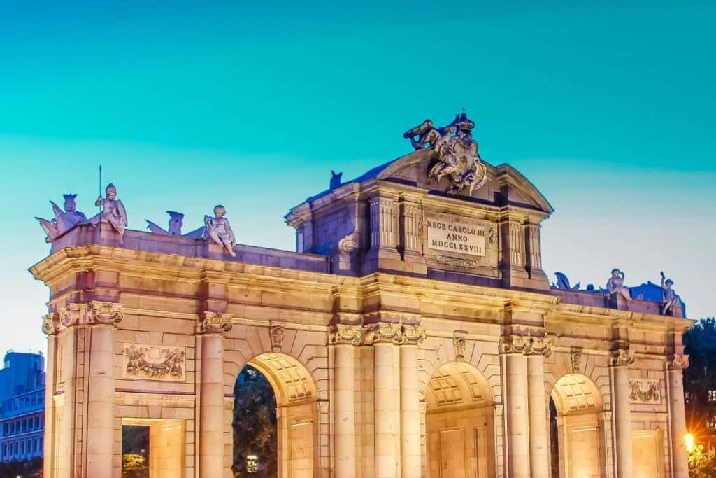 Madrid Royal Palace entrance with ornate architecture and sculptures.