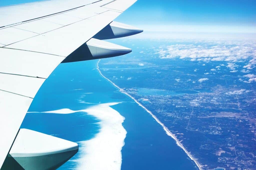 Airplane wing view over the Atlantic Ocean heading to Spain.