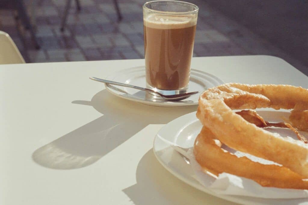 Traditional churros served with a glass of coffee in Malaga.