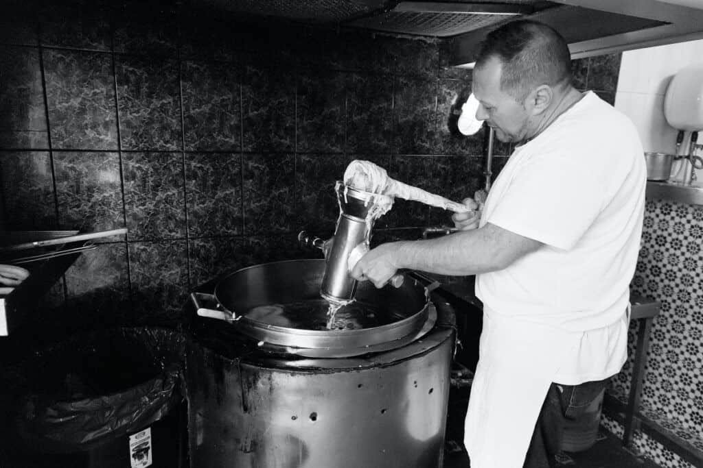 Chef making churros in a traditional churrería in Malaga.