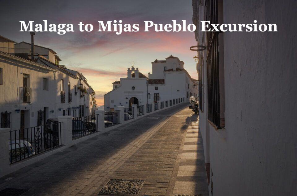Scenic view of Mijas Pueblo street during sunset, highlighting the charming whitewashed buildings.