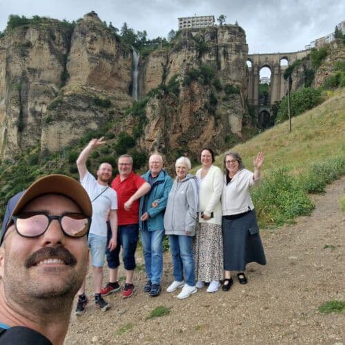 Group of tourists enjoying a guided tour at a historic site in Costa del Sol.