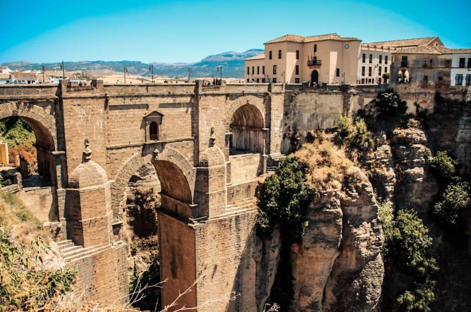 Iconic Ronda bridge over deep gorge with historic buildings in the background.