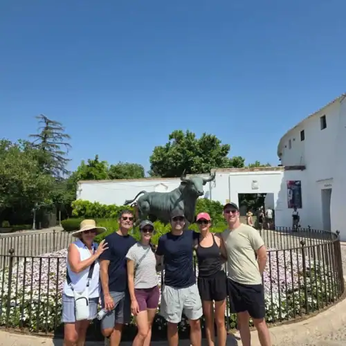 Group of tourists at Malaga historical site during a personalized tour.