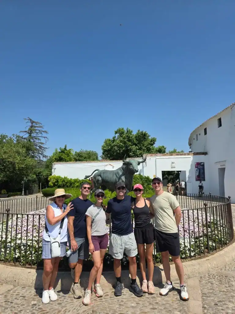 Group of tourists at Malaga historical site during a personalized tour.