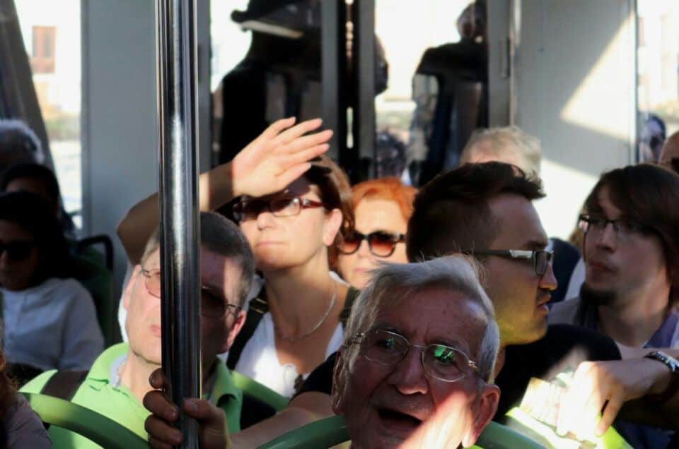 Tourists on a bus enjoying a day trip to Ronda, Spain.