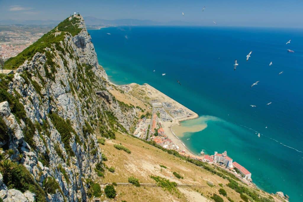 A breathtaking aerial view of the Rock of Gibraltar overlooking the Mediterranean Sea and bustling c.