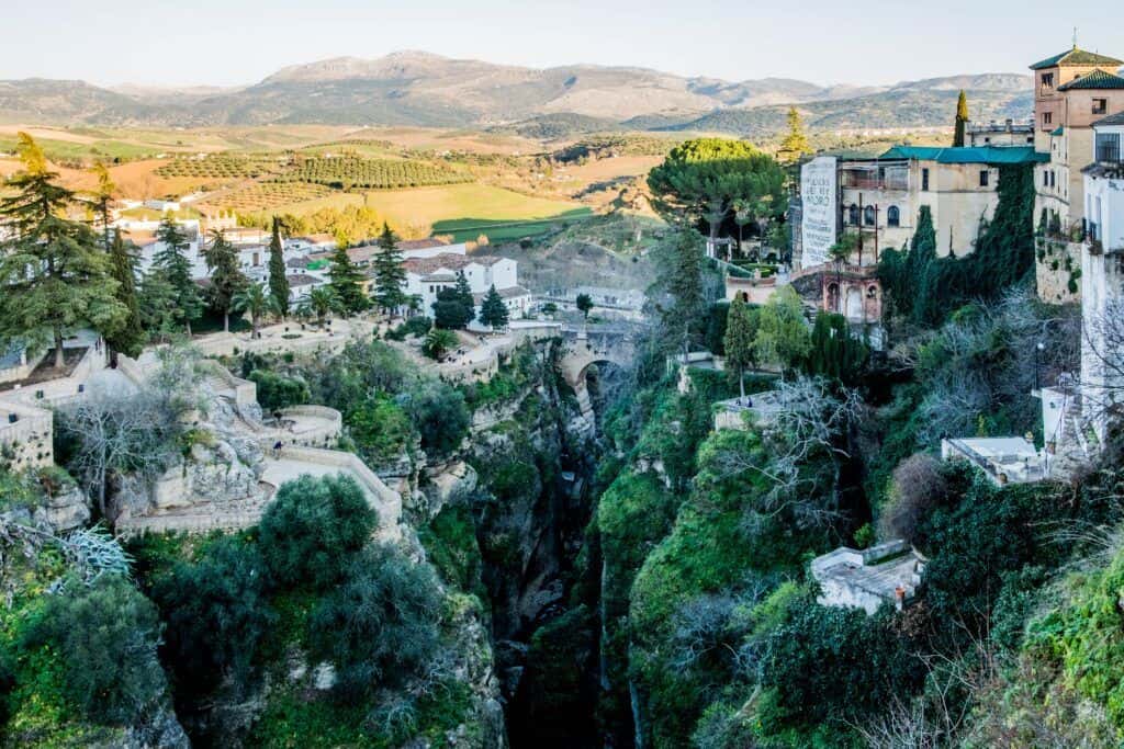 Beautiful landscape of Ronda with historic bridges and lush greenery.